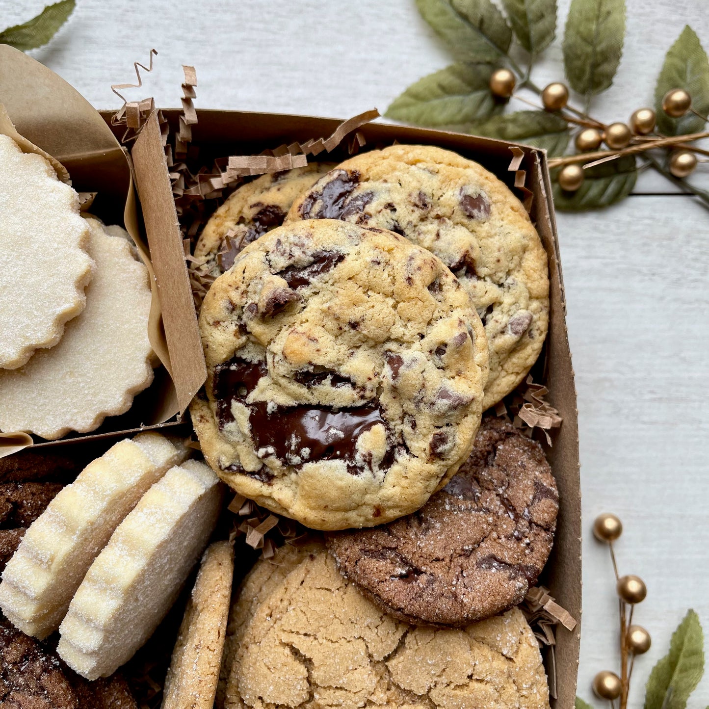 Holiday cookie gift box with chocolate ginger cookies, vanilla shortbread, brown sugar cookies, and chocolate chunk cookies.