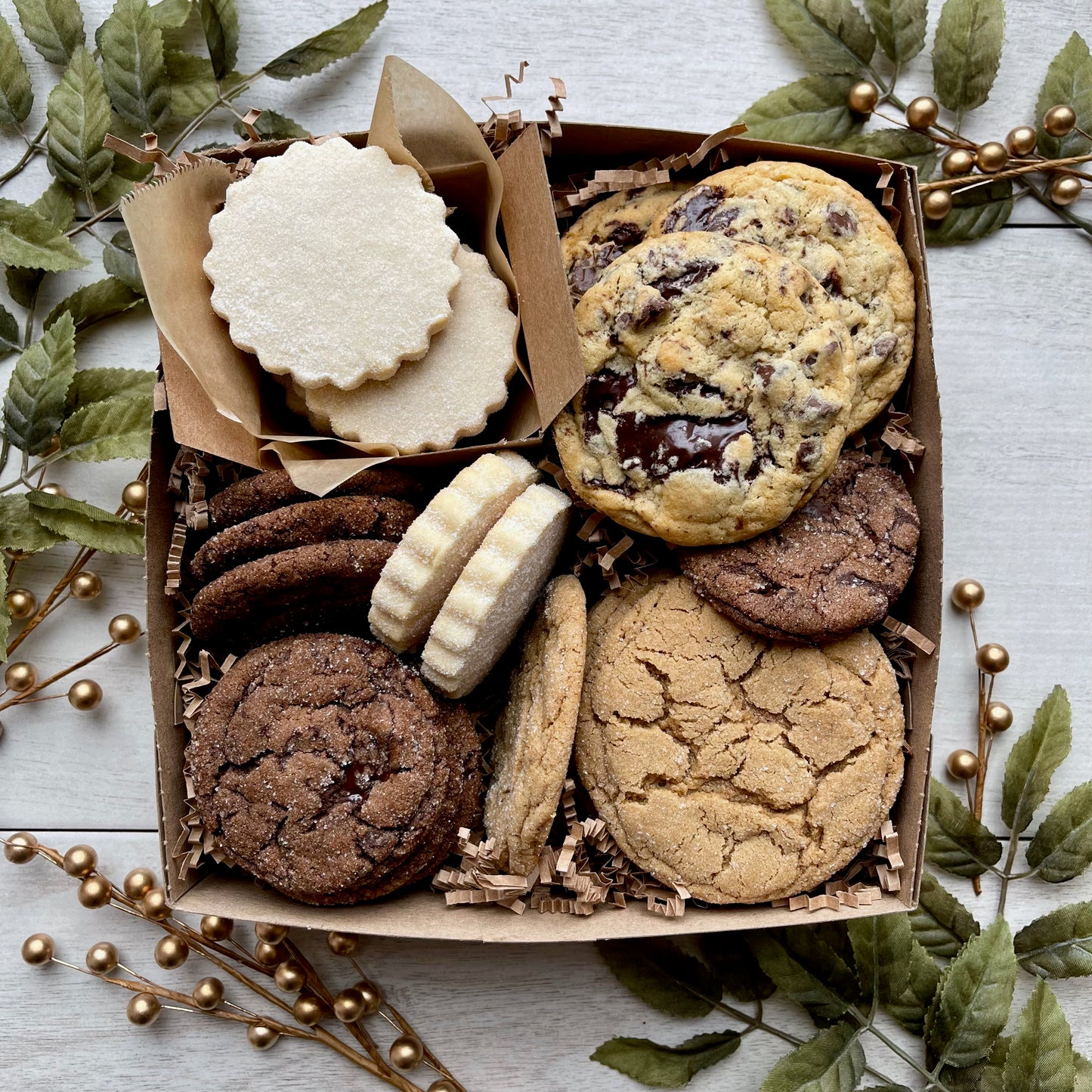 Holiday cookie gift box with chocolate ginger cookies, vanilla shortbread, brown sugar cookies, and chocolate chunk cookies.